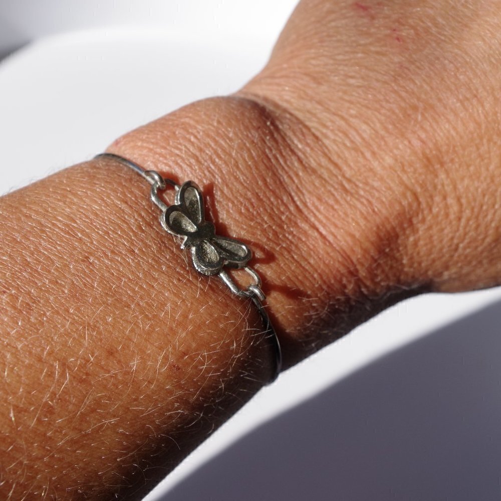 Women`s silver tone butterfly bracelet. 2 1/8 insi